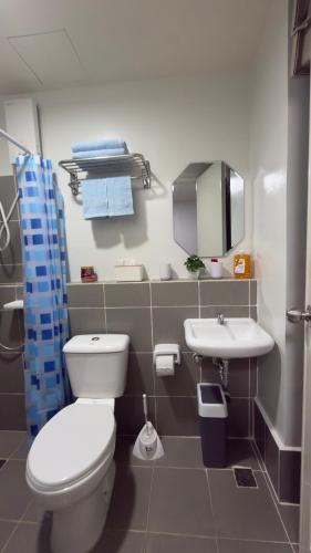 a bathroom with a toilet and a sink at Camella Verdant - Dolcevita Residence in Puerto Princesa City