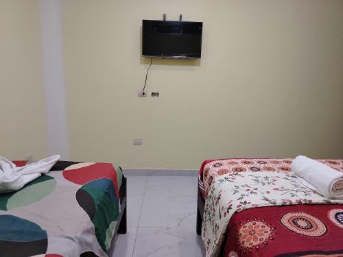 En eller flere senge i et værelse på Departamento Vacacional