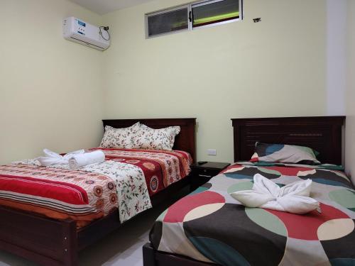 En eller flere senge i et værelse på Departamento Vacacional