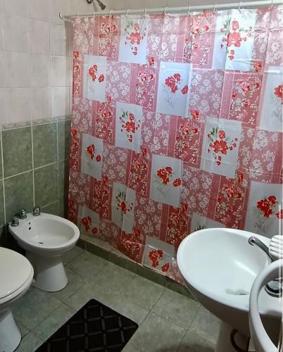 a bathroom with a sink and a toilet and a shower curtain at Quintacolastinenorte in Santa Fe