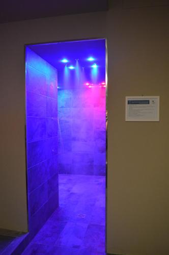 a walk in shower with blue and purple lights at Euroterme in Bagno di Romagna