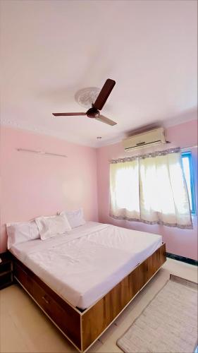 ein Schlafzimmer mit einem Bett mit Deckenventilator in der Unterkunft Silver ok appartment in Shirdi