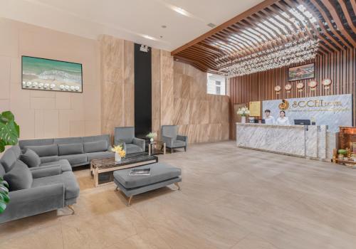 a lobby with couches and a counter in a building at Sochi Hotel in Nha Trang