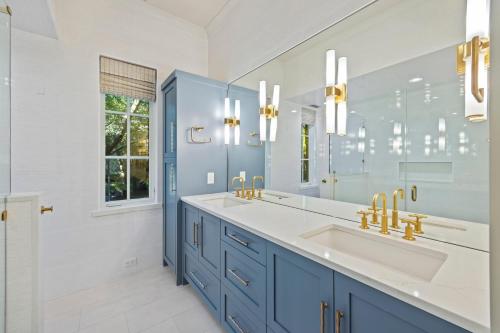 a blue bathroom with a sink and a mirror at 5556 Cypress Point in Kiawah Island