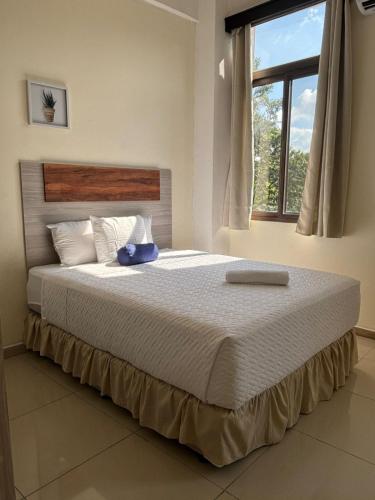 A bed or beds in a room at Hotel Harvest Retalhuleu