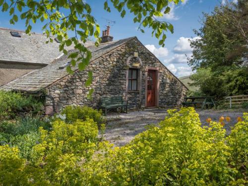an old stone house with a red door at 1 Bed in Penrith oc-sz295 in Dockray