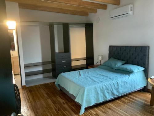 a bedroom with a bed with a blue comforter at Habitacion en Villakite ,Salinas del Rey in Juan de Acosta