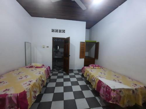 Ένα ή περισσότερα κρεβάτια σε δωμάτιο στο Hospedaje Sadicita