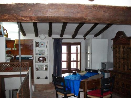 a kitchen with a table with a blue table cloth on it at Casa de la Musica in Calaceite