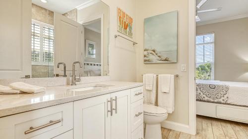 a white bathroom with a sink and a toilet at Casa Antilles - 1036L in Siesta Key