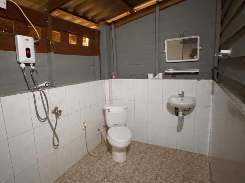 a bathroom with a toilet and a sink at Prey Apsara Bungalows in Koh Rong