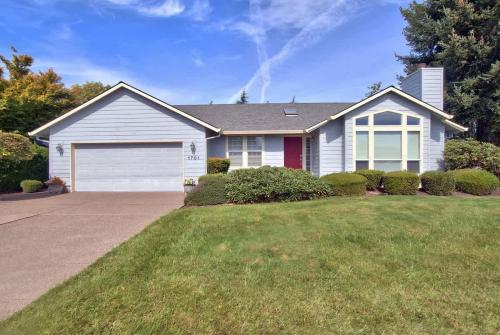 a house with a garage and a grass yard at Mac Haven - Single level golf view wine escape in McMinnville