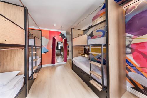 a room with four bunk beds in a room at JO&JOE Auckland in Auckland