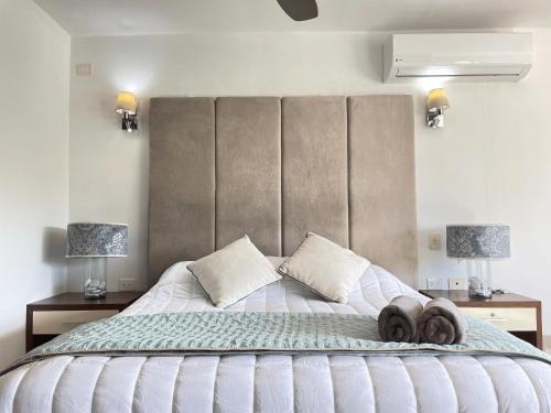 a bedroom with a large bed with towels on it at Marvelous Villa- in the heart of Cancun Hotel Zone in Cancún