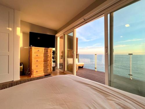 a bedroom with a view of the ocean at Malibu Waterfront Gallery with Private Beach Access in Malibu Beach