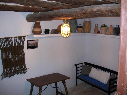a room with a table and a chair and a lamp at Casa de la Musica in Calaceite