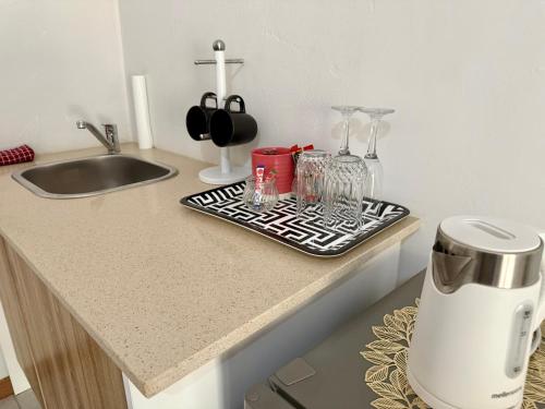 a kitchen counter with a coffee maker on a tray at The Minimalist Suite in Kempton Park
