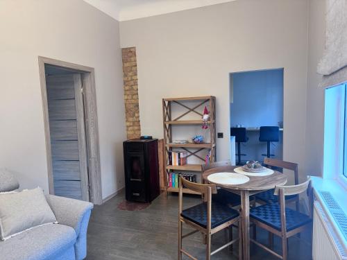 a living room with a table and chairs and a couch at Saulgrieži 7 in Ventspils