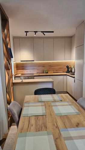 a kitchen with a wooden table in a room at Friends Vlašić in Vlasic