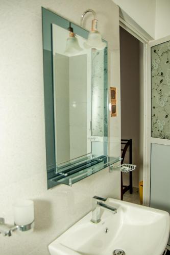 a bathroom with a sink and a mirror at Shan Resort in Gintota