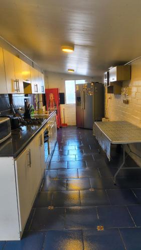 a large kitchen with a counter and a refrigerator at Casa Agustina in Valdivia