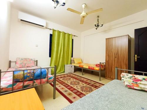 a bedroom with two bunk beds and a window at Terhal guest house in Muscat