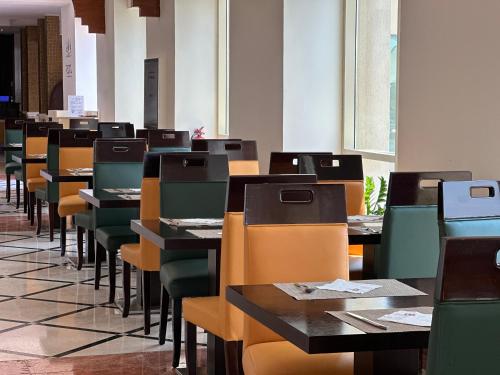 a row of tables and chairs in a room at Western Hotel - Ghayathi in Ghayathi
