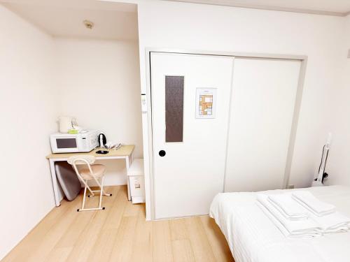 Ένα ή περισσότερα κρεβάτια σε δωμάτιο στο 東三国民泊