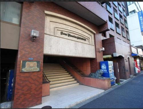 a building with a door and stairs in front of it at SJins in Tokyo