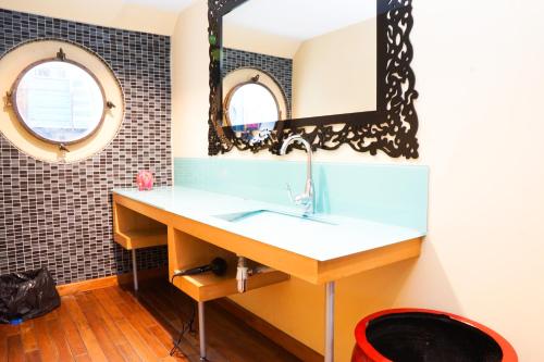 a bathroom with a sink and a mirror at EXIGEHOME-Large houseboat with spa near Paris in Saint-Cloud