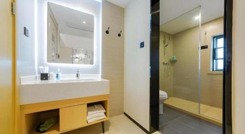 a bathroom with a sink and a shower and a toilet at City Comfort Inn Wuhan Ikea in Wuhan