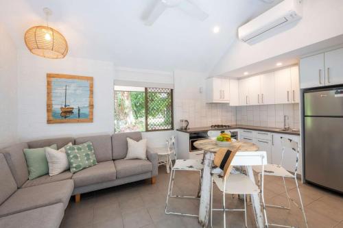 a kitchen and living room with a couch and a table at Bayshore Bungalow 8 - Oceanstays in Byron Bay