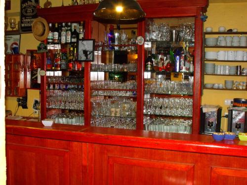 a bar with a lot of alcohol bottles and glasses at La Petite France in San José de Maipo