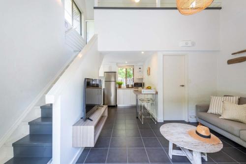 a living room with a couch and a table at Bayshore Bungalow 4 - Oceanstays in Byron Bay