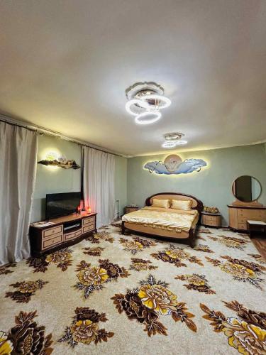 a bedroom with a bed and a television in a room at Mandakh Naran Guest House in Dzuunmod