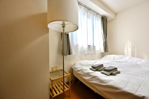 Giường trong phòng chung tại コングラッツ湘南