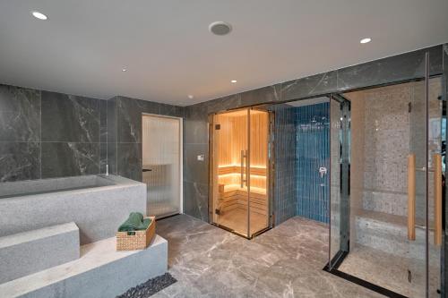 a bathroom with a shower and a walk in shower at Amaya Saigon Boutique Hotel in Ho Chi Minh City