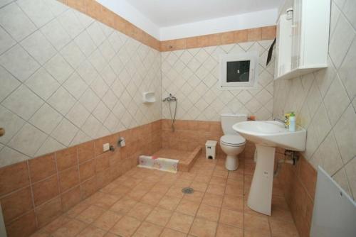 a bathroom with a toilet and a sink at Palman Othonoi House in Othonoi