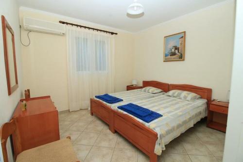 a bedroom with a bed and a chair in it at Palman Othonoi House in Othonoi