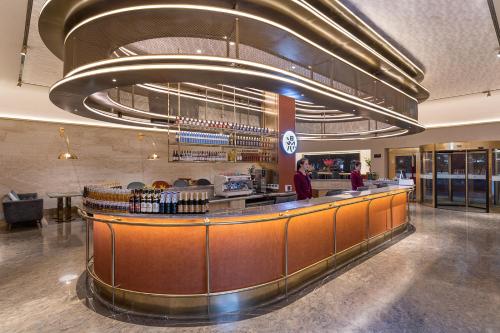 a restaurant with a bar with people standing around it at Beijing Tiananmen Square Manxin Hotel in Beijing