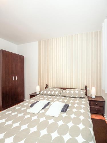 a large bedroom with a large bed and a wooden cabinet at Apartments The Old Well in Gornji Vaganac