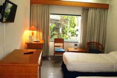 En eller flere senge i et værelse på Hotel Marcopolo