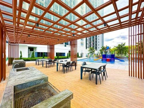 a patio with tables and chairs in a building at UKM GMI Mirai Residence Kajang 2 in Kajang