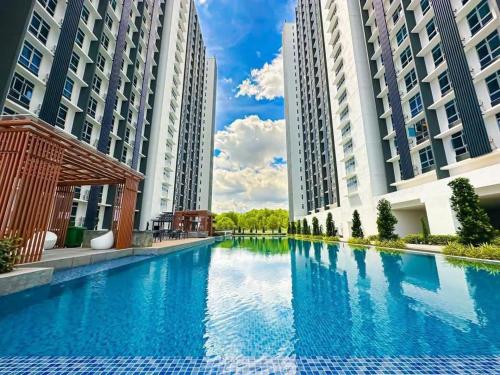a large swimming pool with two tall buildings at UKM GMI Mirai Residence Kajang 2 in Kajang