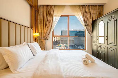 a bedroom with a large bed with a large window at GGIVV VACATION HOMES RENTAL 1400 FT 1 BEDROOM LUXURY SERVICE Apartment in Dubai