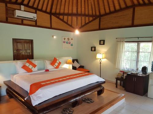 a bedroom with a large bed in a room at Angel Island Eco Resort in Labuan Bajo