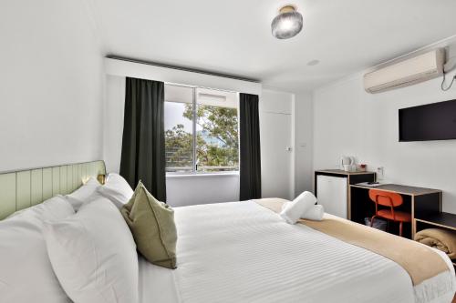 Ένα ή περισσότερα κρεβάτια σε δωμάτιο στο The Palms Motel- Formerly Flinders Motel