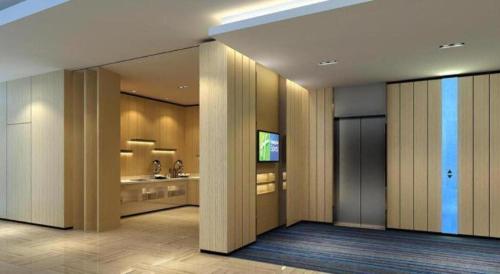 a lobby with wooden columns and a television in a building at Holiday Inn Express Zhangye By IHG in Zhangye