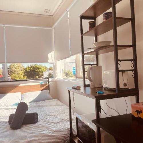 a bedroom with a bunk bed with a desk and a window at Bus Mac Uni Mac Centre Bright and Sunny in Sydney