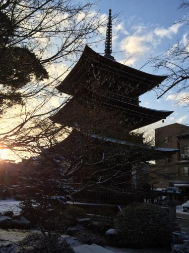 a pagoda with snow on it in front at Takayama Ninja House in Takayama